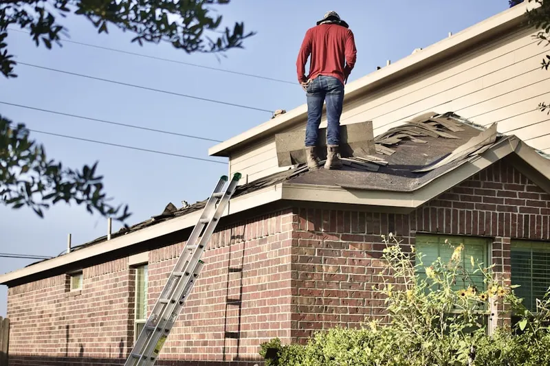 Professional roofer working on a residential roof in Lisbon Meadows